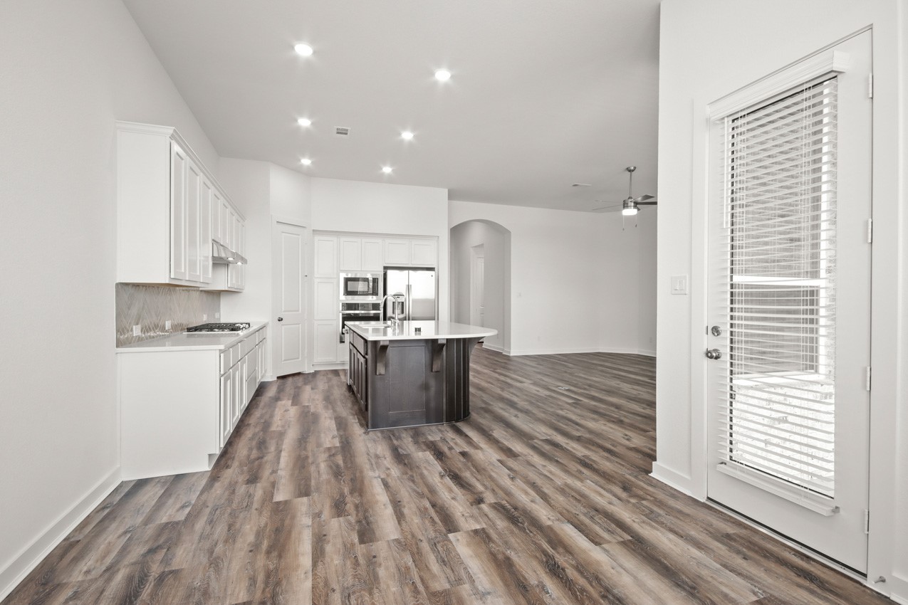 16538 Mandora Lane Conroe, TX 77302 - Photo 8 of 22 a kitchen view with wooden floor and electronic appliances