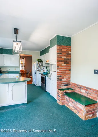 a kitchen with kitchen island a sink stove and cabinets