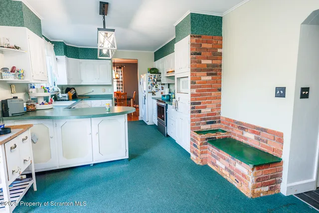 a dining room with wooden floor and furniture