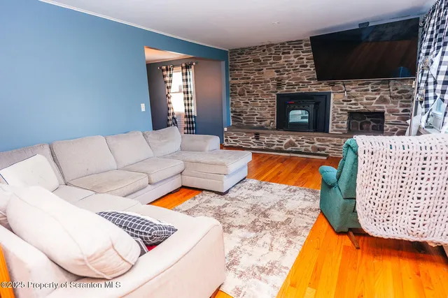 a living room with a fireplace and a flat screen tv