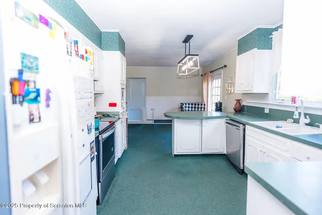 a room with pool table and kitchen view