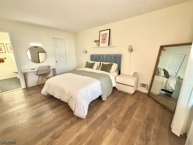 a bed room with a bed and a chair