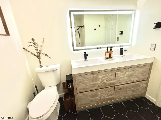 a bathroom with a toilet sink and mirror