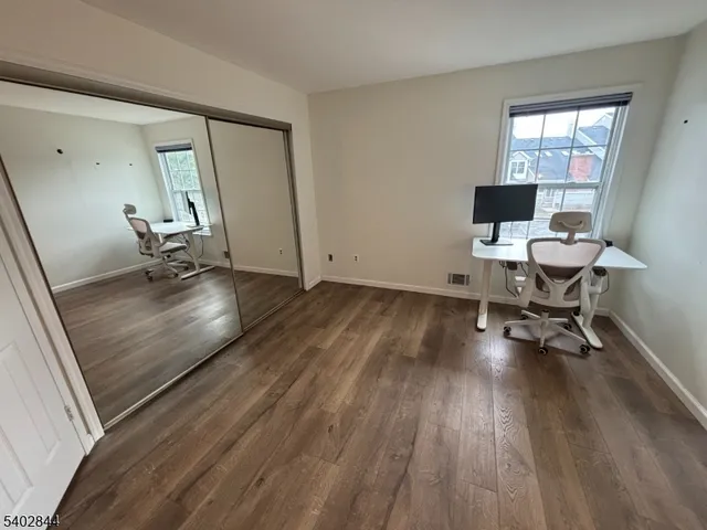 a workspace with wooden floor and a window