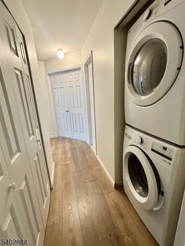 a view of a hallway with washer and dryer