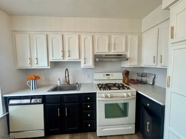 a kitchen with stainless steel appliances granite countertop a sink stove and cabinets