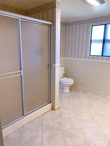 a bathroom with a toilet a sink and shower