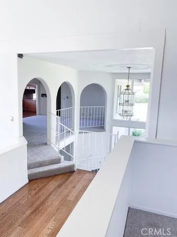 a view of entryway and hall with wooden floor