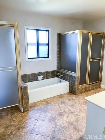 a spacious bathroom with a tub and a shower