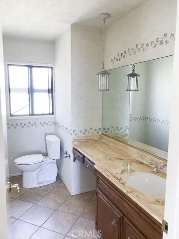a bathroom with a granite countertop sink a toilet and a bathtub
