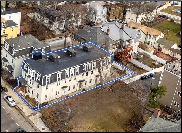 an aerial view of a house with a street