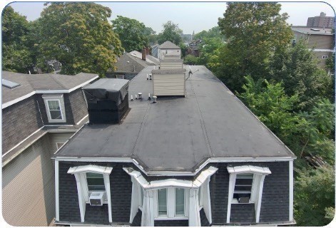 94 Walnut Avenue Boston, MA 02119 - Photo 4 of 4 a aerial view of a house with a yard