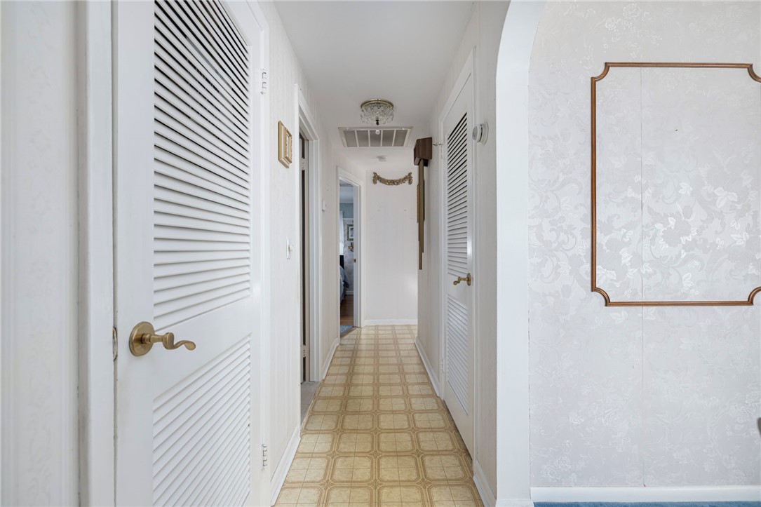 39 Holiday Avenue Warwick, RI 02888 - Photo 11 of 35 Heading down the hall, you'll find the formal living room, full bath and three bedrooms.