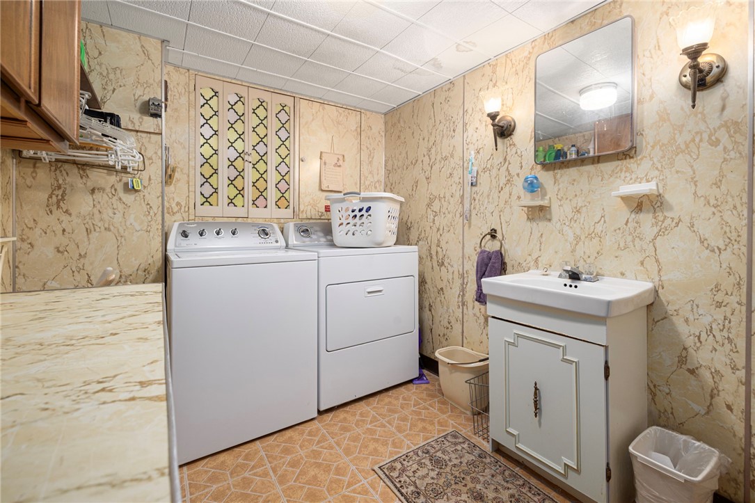 39 Holiday Avenue Warwick, RI 02888 - Photo 23 of 35 The lower level offers a spacious laundry room including a washer, dryer, sink and retractable folding table. There is also a half bath in the lower level.