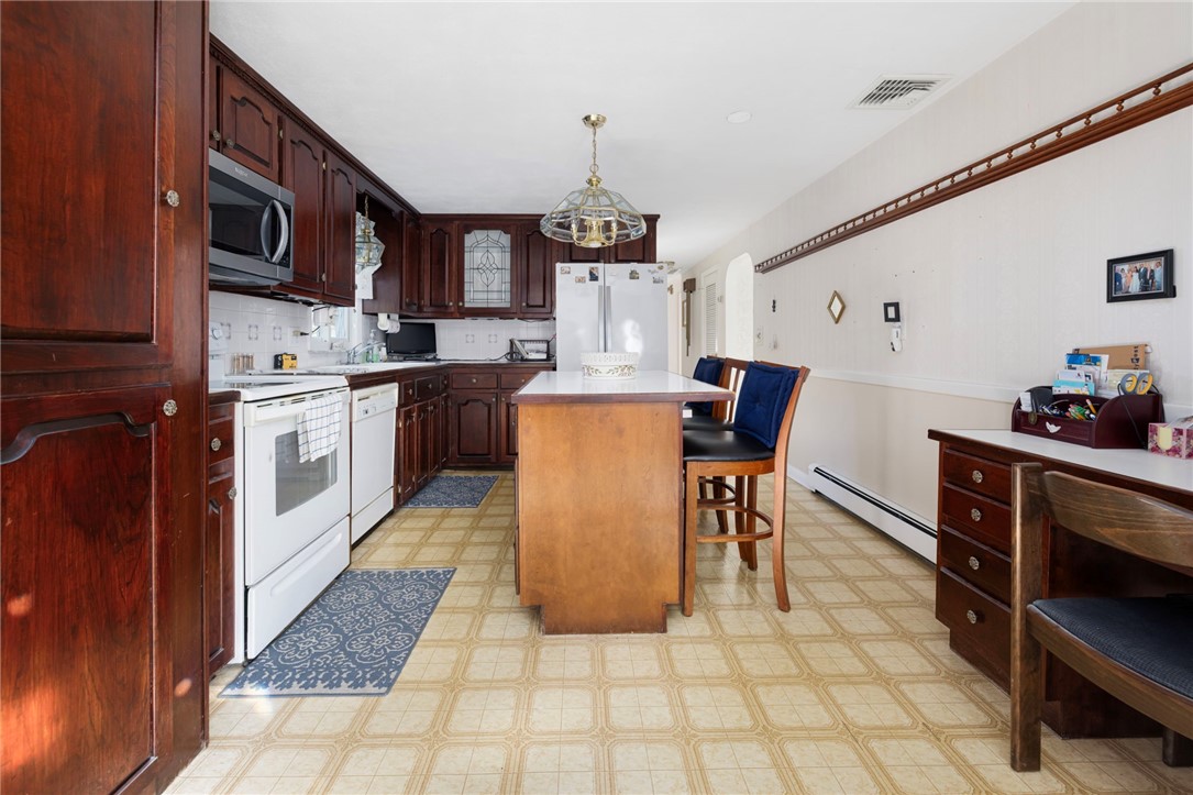39 Holiday Avenue Warwick, RI 02888 - Photo 8 of 35 The kitchen is a good size and features a center island.