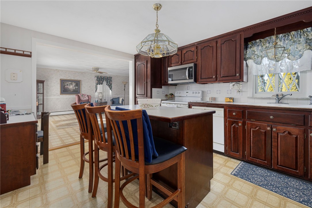 39 Holiday Avenue Warwick, RI 02888 - Photo 9 of 35 Another perspective of the eat-in-kitchen showcases the fantastic, open layout that is perfect for entertaining.