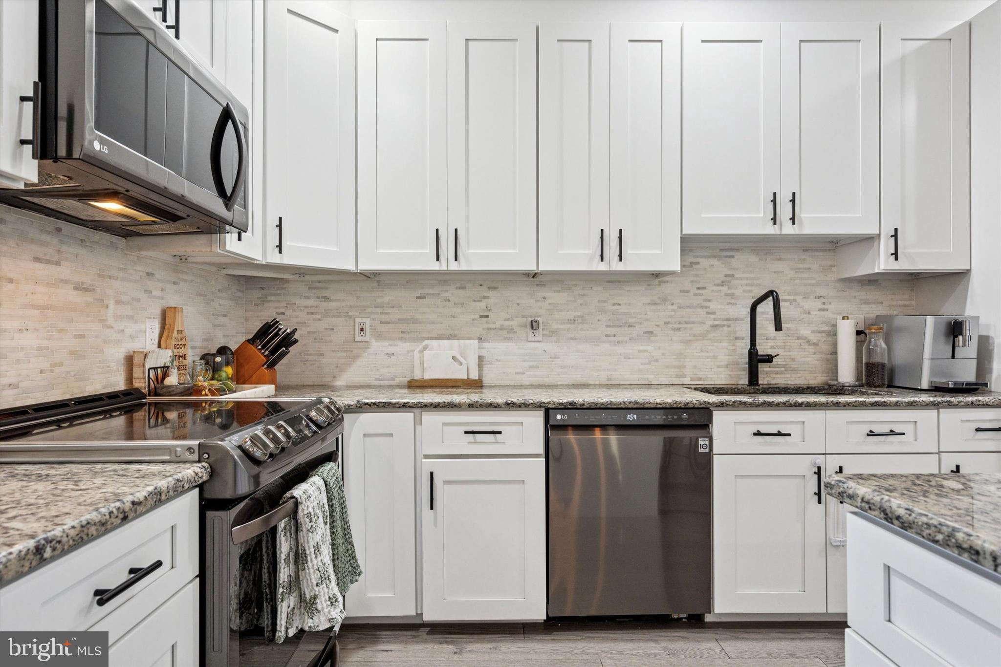 2694 Bridge Street Philadelphia, PA 19137 - Photo 9 of 41 a kitchen with stainless steel appliances granite countertop a sink stove and cabinets