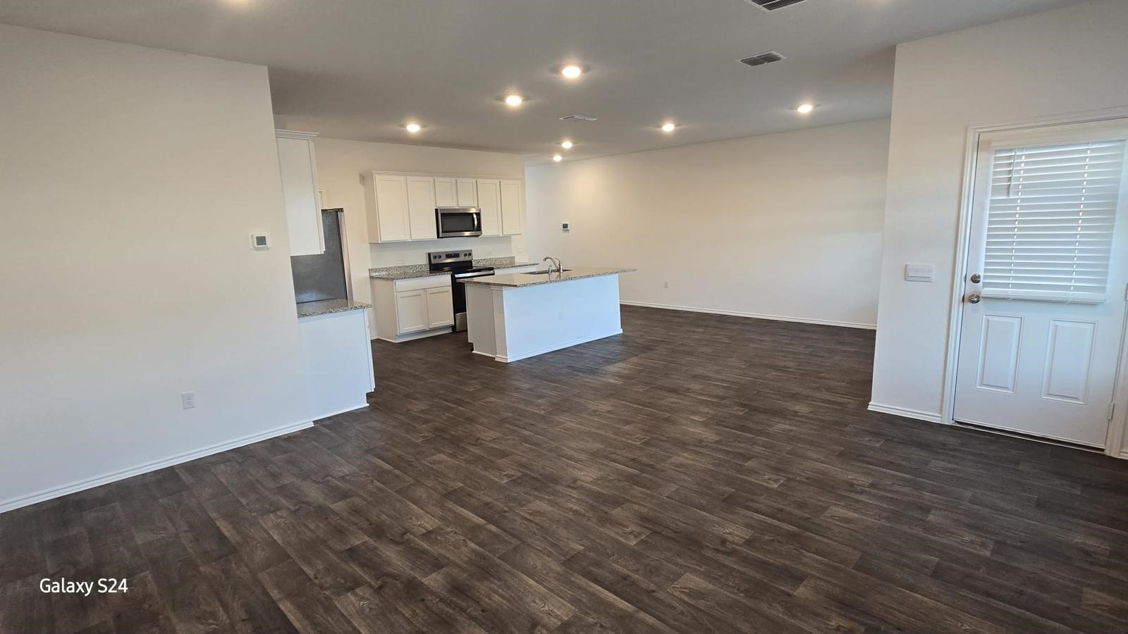 14821 Perlino Way, Unit A Manor, TX 78653 - Photo 5 of 20 a view of kitchen with kitchen island stainless steel appliances wooden floor and window