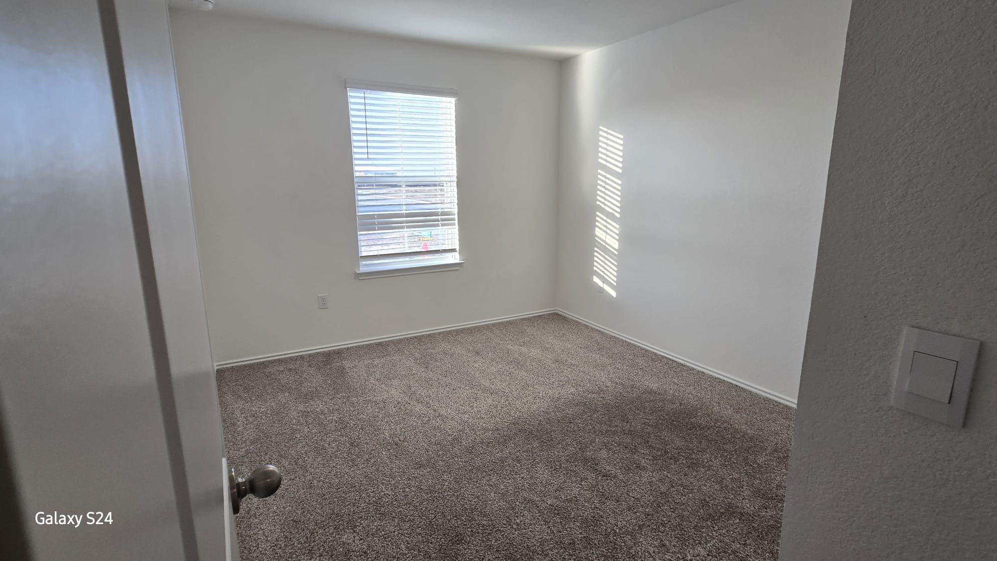 14821 Perlino Way, Unit A Manor, TX 78653 - Photo 9 of 20 an empty room with windows
