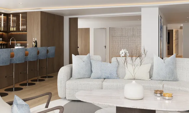 a living room with couches and kitchen view