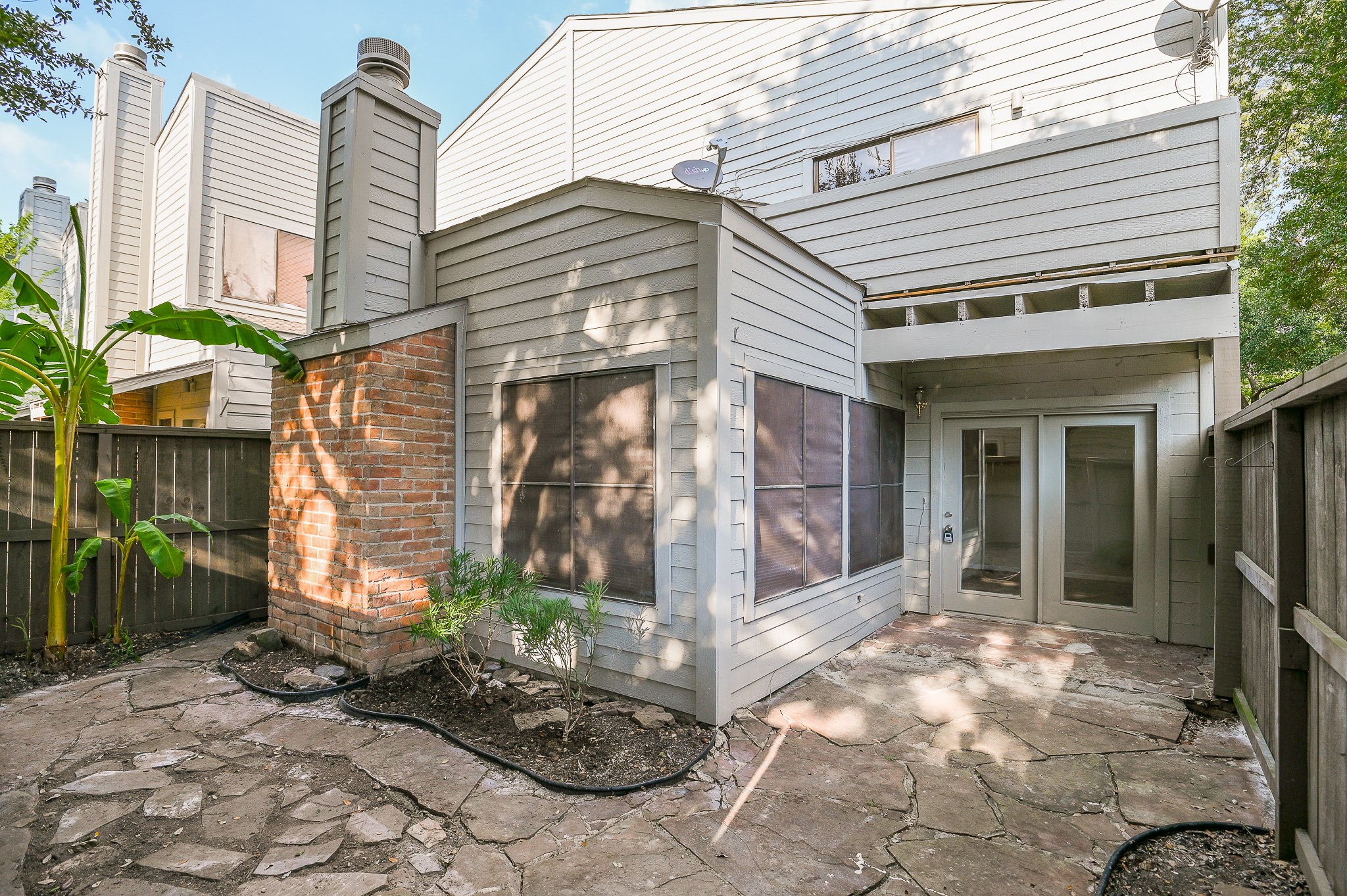 a view of a house with a yard and sitting area