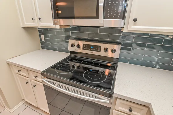 a close view of a stove top oven sitting inside of a kitchen