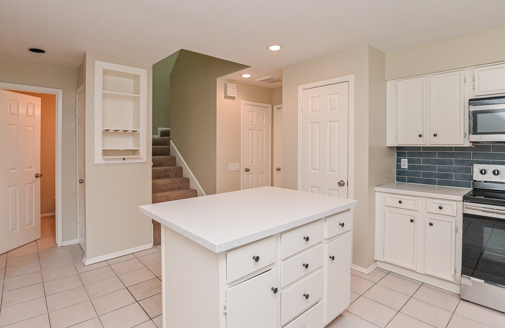 1619 Prairie Mark Lane Houston, TX 77077 - Photo 13 of 25 a kitchen with white cabinets
