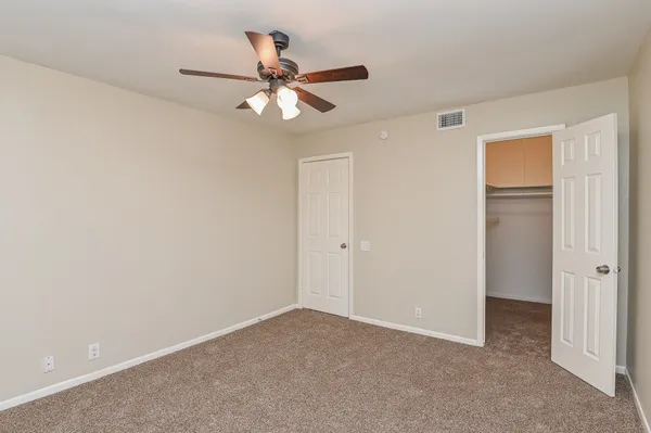 a view of a room with a ceiling fan