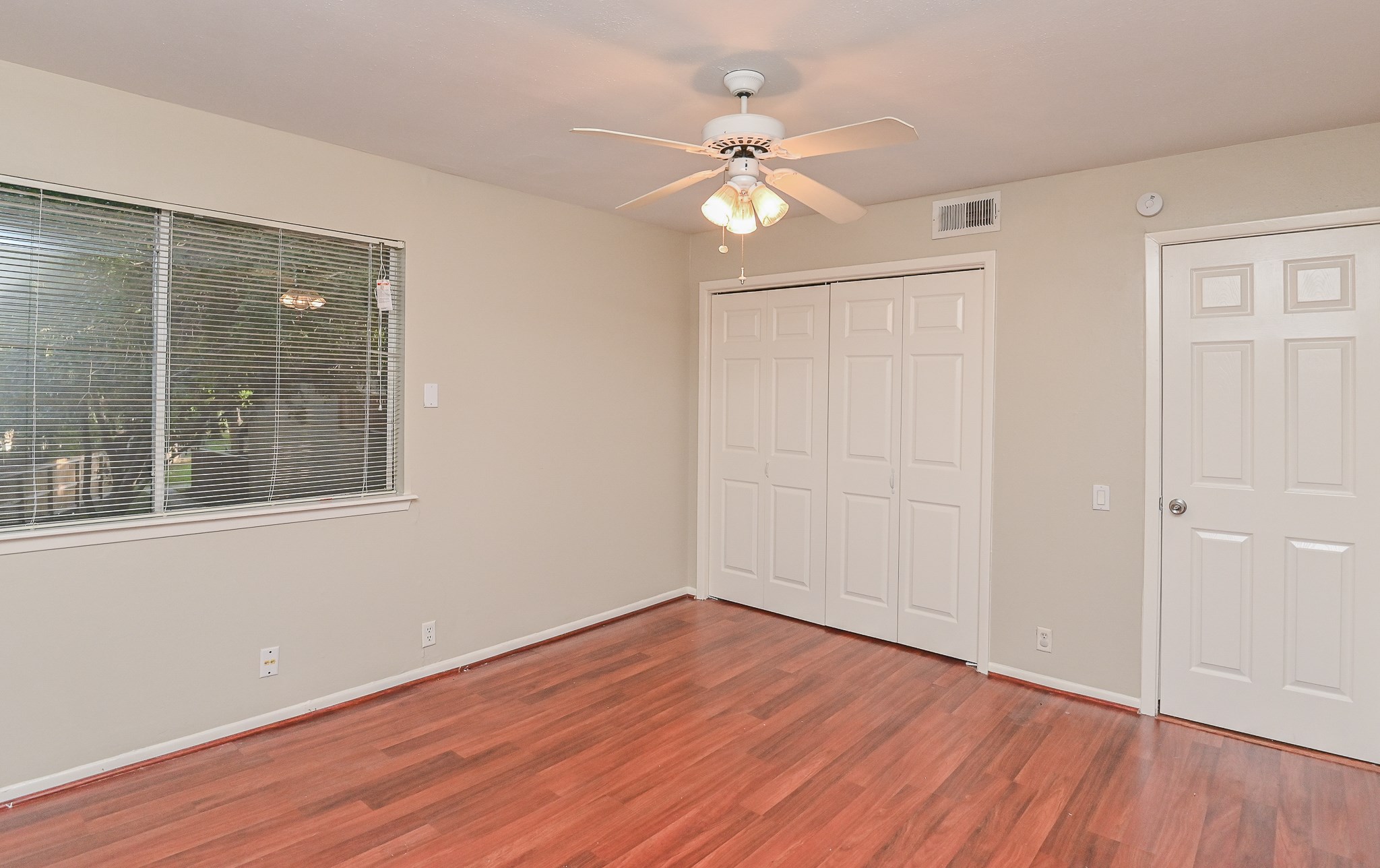1619 Prairie Mark Lane Houston, TX 77077 - Photo 15 of 25 a view of an empty room with wooden floor and a window