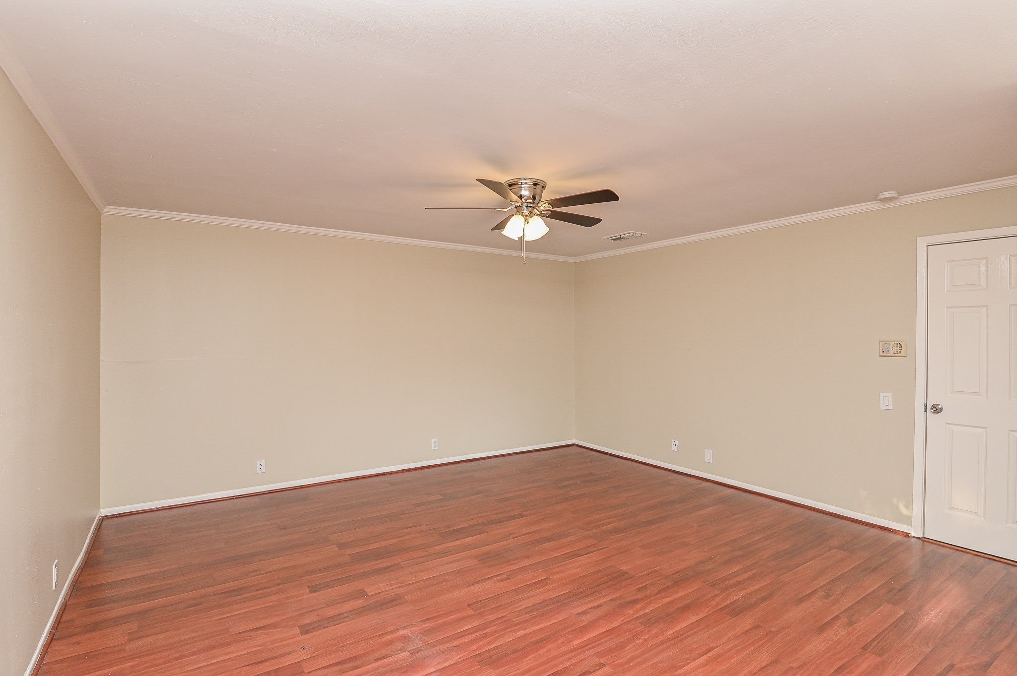 1619 Prairie Mark Lane Houston, TX 77077 - Photo 18 of 25 a view of a room with wooden floor and a ceiling fan