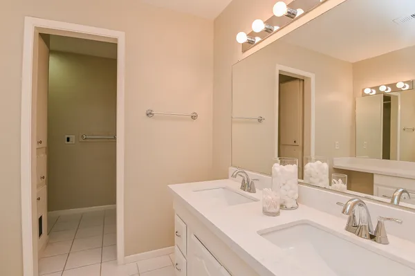 a bathroom with a sink vanity and mirror