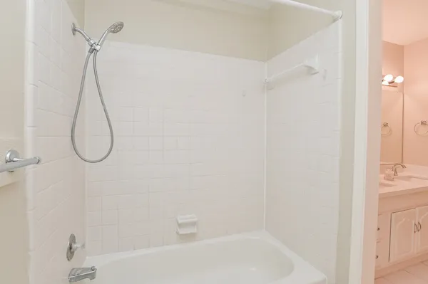 a bathroom with a bath tub with a shower