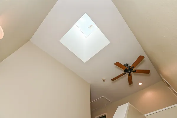 a view of a hallway with a ceiling fan