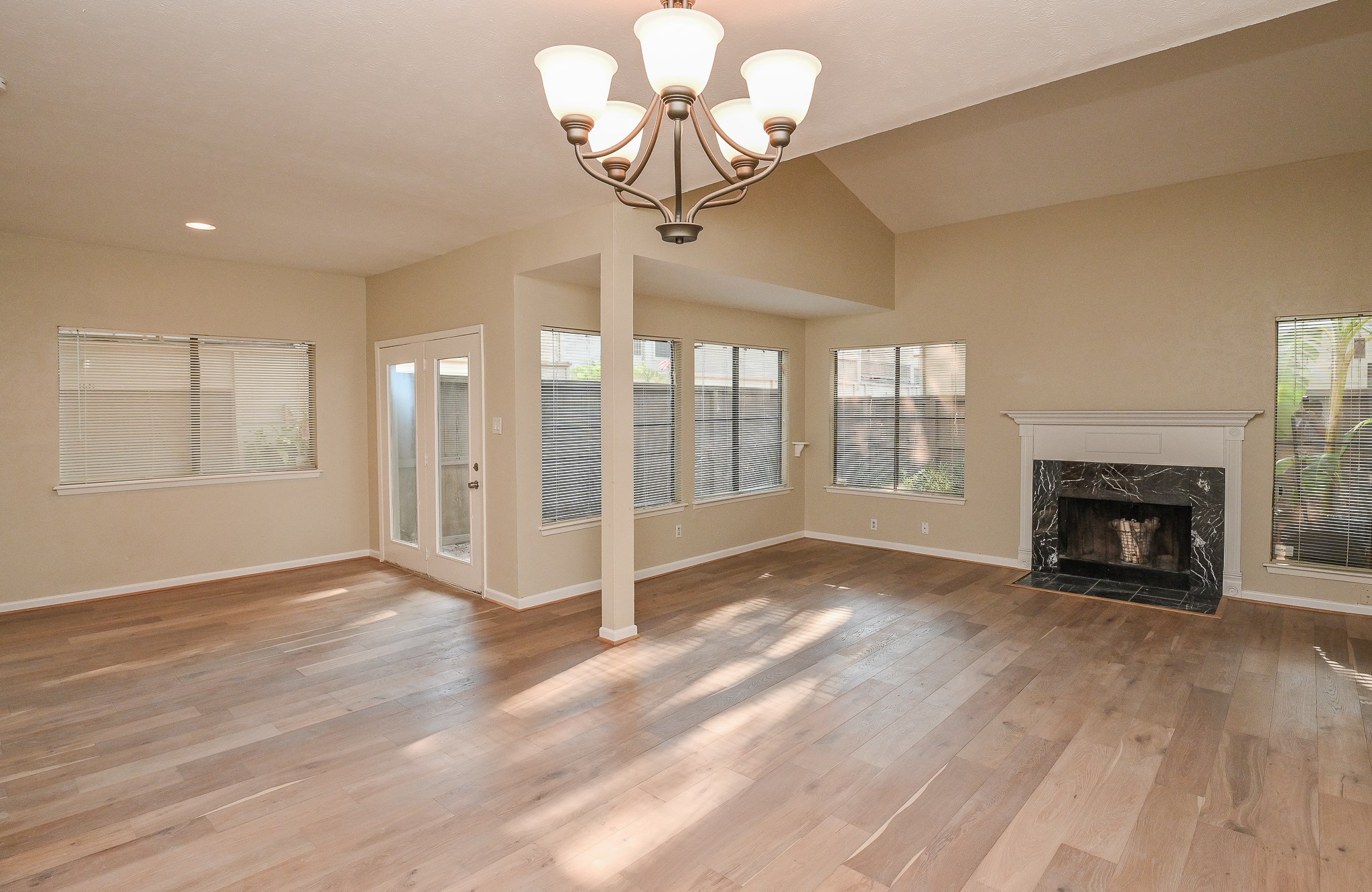1619 Prairie Mark Lane Houston, TX 77077 - Photo 5 of 25 a view of an empty room with a fireplace and a window