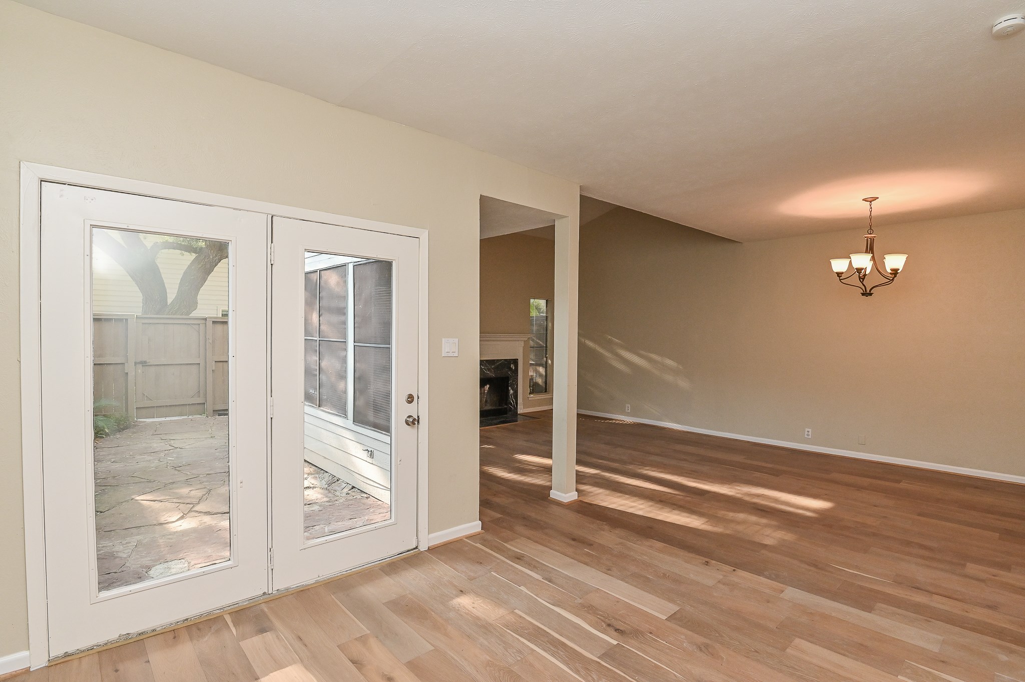 1619 Prairie Mark Lane Houston, TX 77077 - Photo 6 of 25 an empty room with wooden floor and door