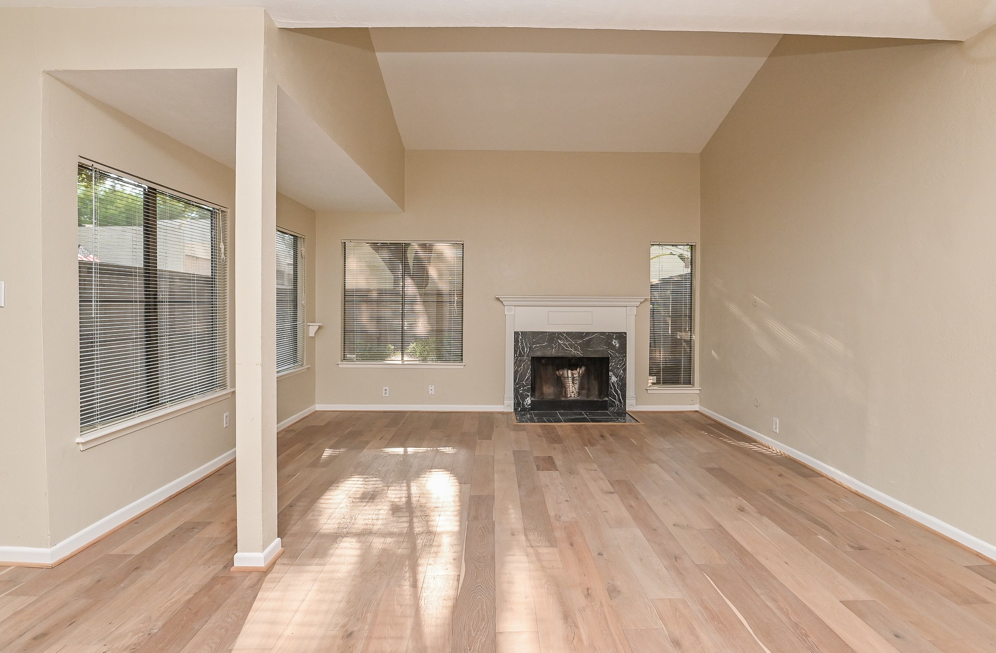 1619 Prairie Mark Lane Houston, TX 77077 - Photo 7 of 25 a view of an empty room with a fireplace and a window