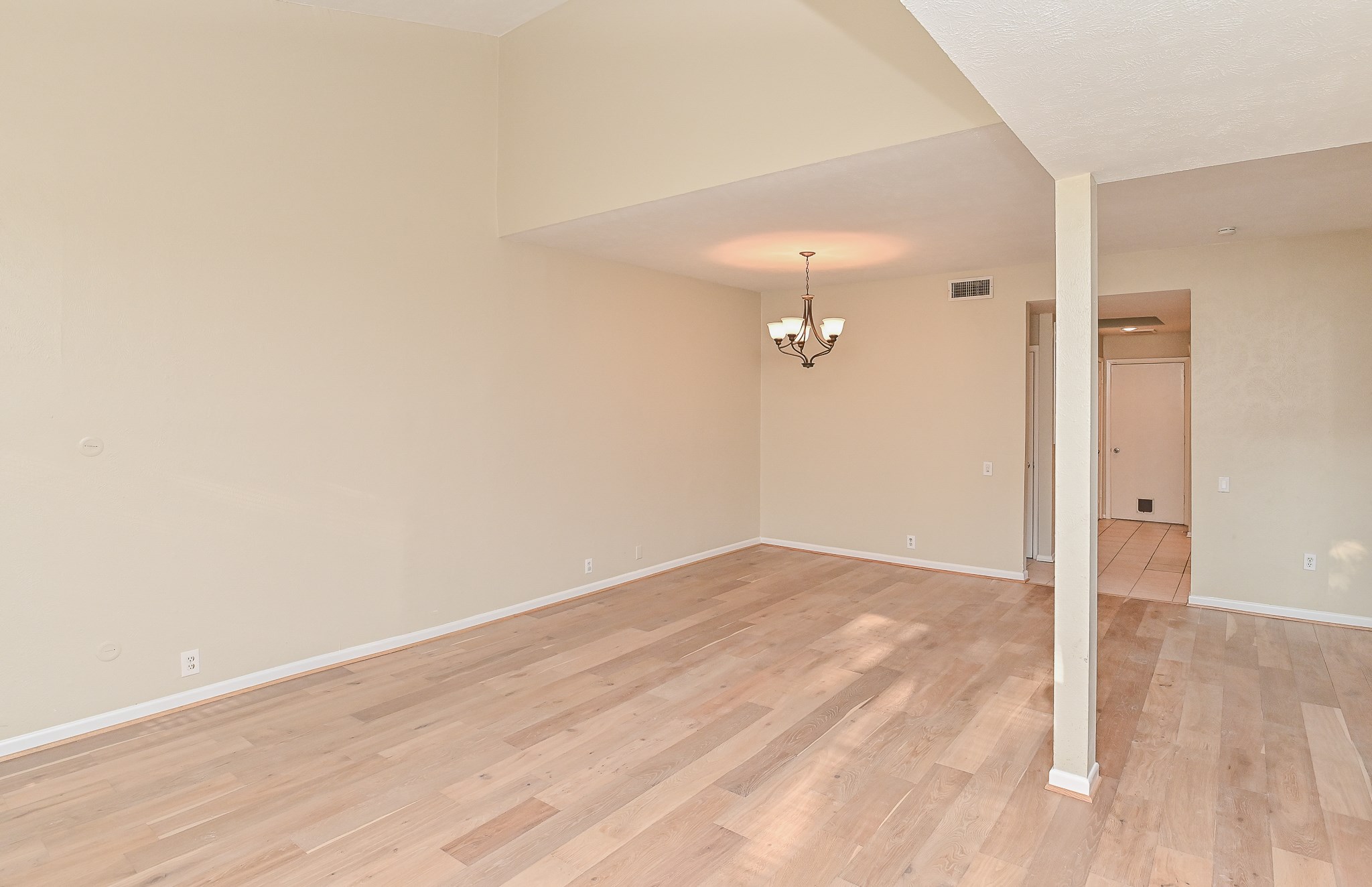 1619 Prairie Mark Lane Houston, TX 77077 - Photo 10 of 25 an empty room with wooden floor and cabinet