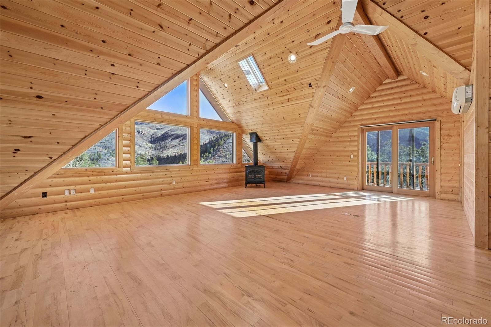 7415 Highway 24 Cascade, CO 80809 - Photo 21 of 45 a view of an empty room with wooden floor and a window
