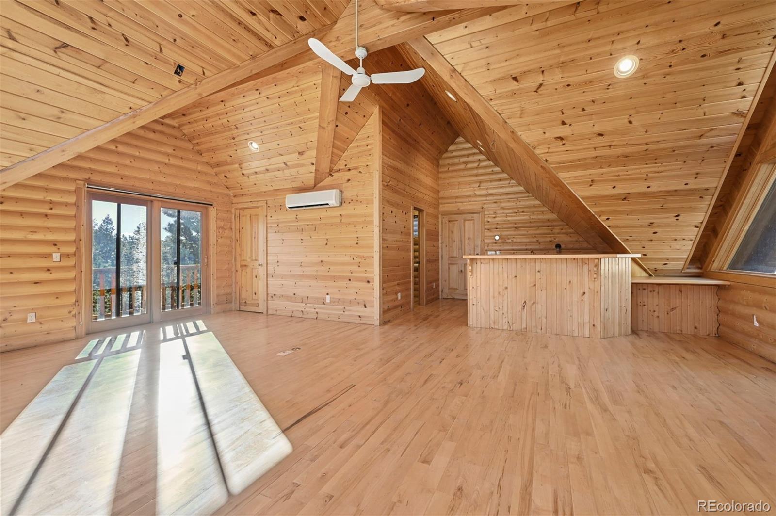 7415 Highway 24 Cascade, CO 80809 - Photo 24 of 45 a view of an empty room with wooden floor and windows