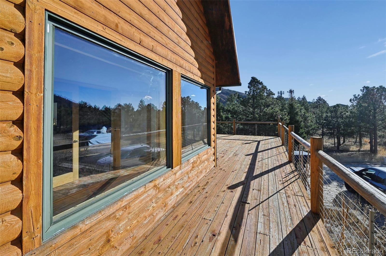 7415 Highway 24 Cascade, CO 80809 - Photo 26 of 45 a balcony with view of trees in the background