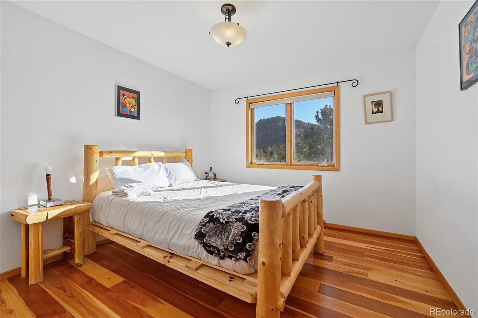 7415 Highway 24 Cascade, CO 80809 - Photo 37 of 45 a bedroom with a bed and a painting on the wall