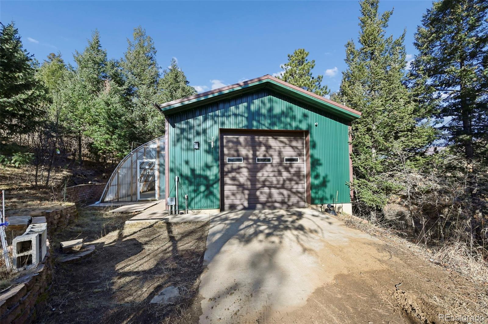 7415 Highway 24 Cascade, CO 80809 - Photo 43 of 45 a front view of a house with a yard