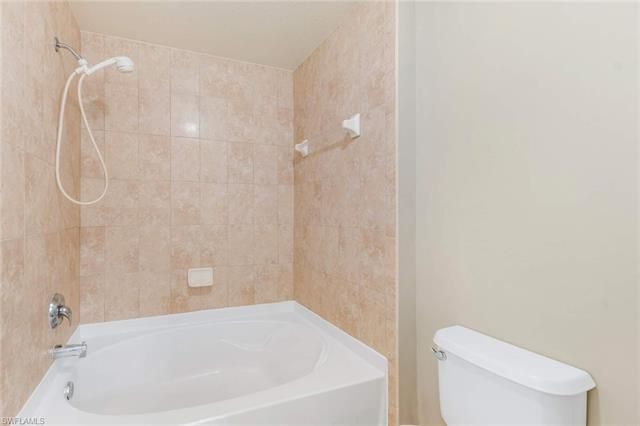 a bathroom with a white bath tub and a shower