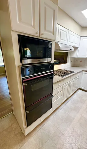 a view of a room with wooden floor and a window