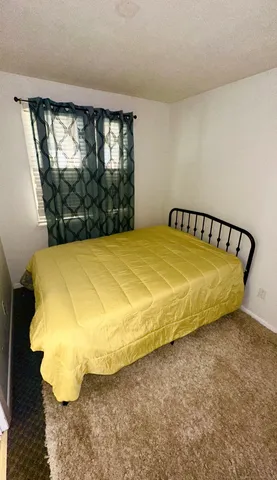 a bedroom with furniture and a wooden floor