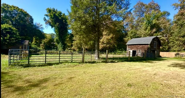 a view of a house with swimming pool and sitting area