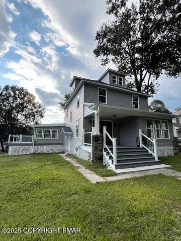 a view of a house with a yard porch and sitting area