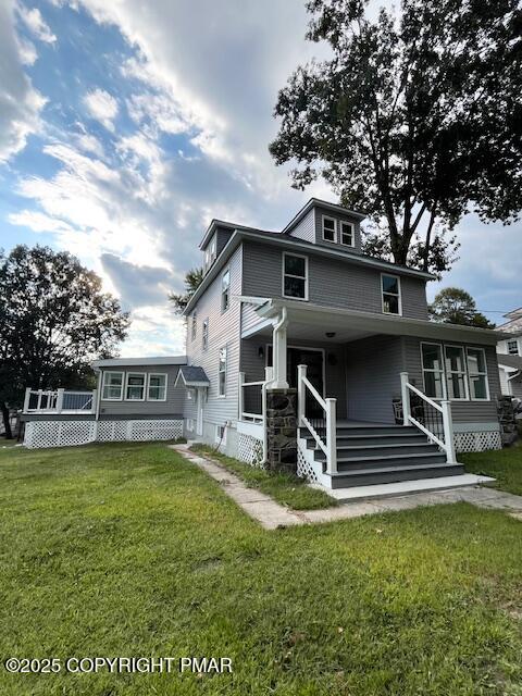 a view of a house with a yard porch and sitting area
