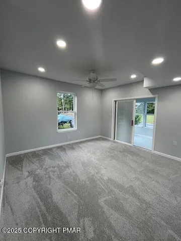 a view of an empty room and a window