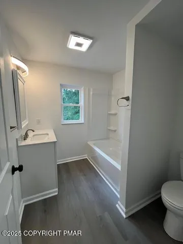 a bathroom with a sink a toilet and tub